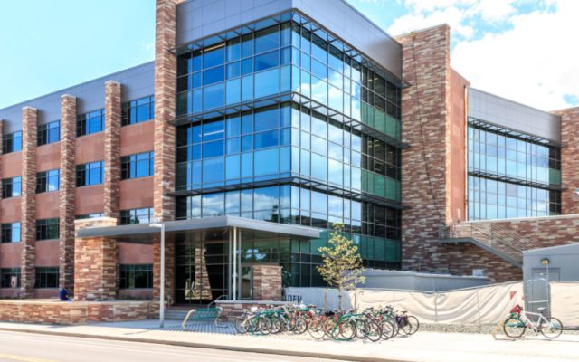 A Building With Brick Pillars With Glass Window