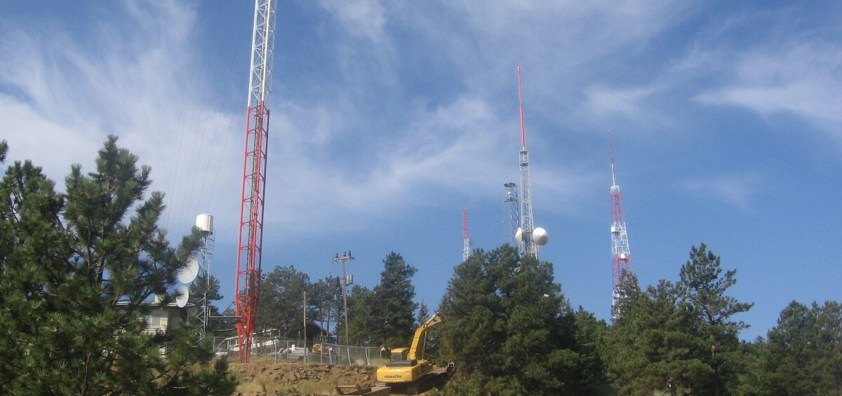 Communication Towers, Dense Vegetation, and Machine